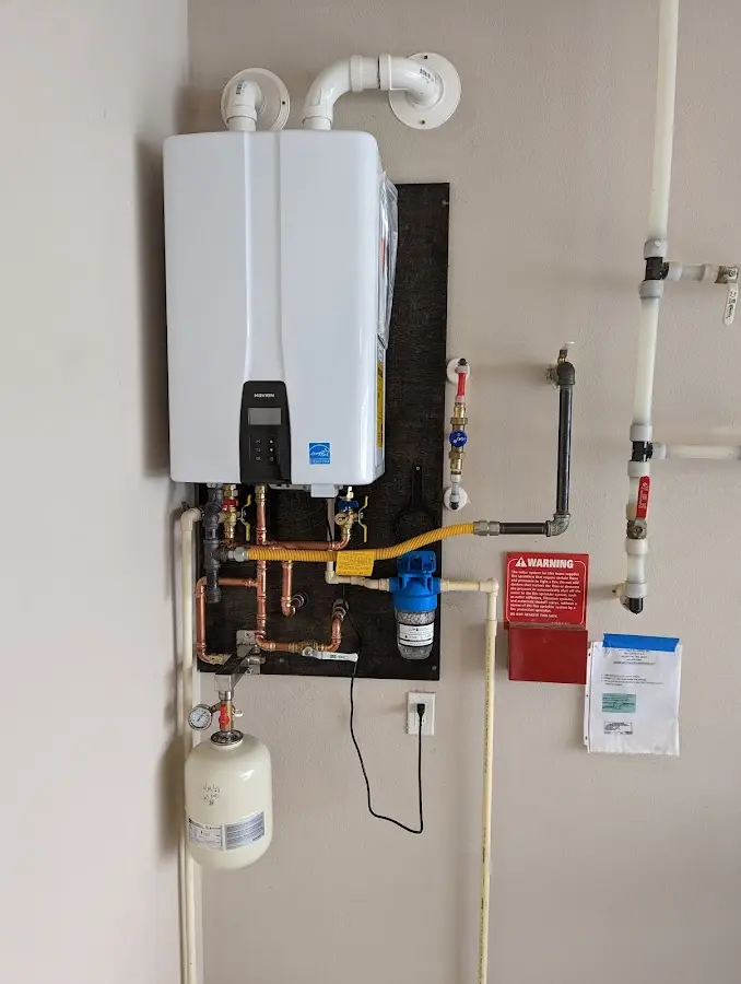 Professional plumber installing copper piping in a Wilkins home